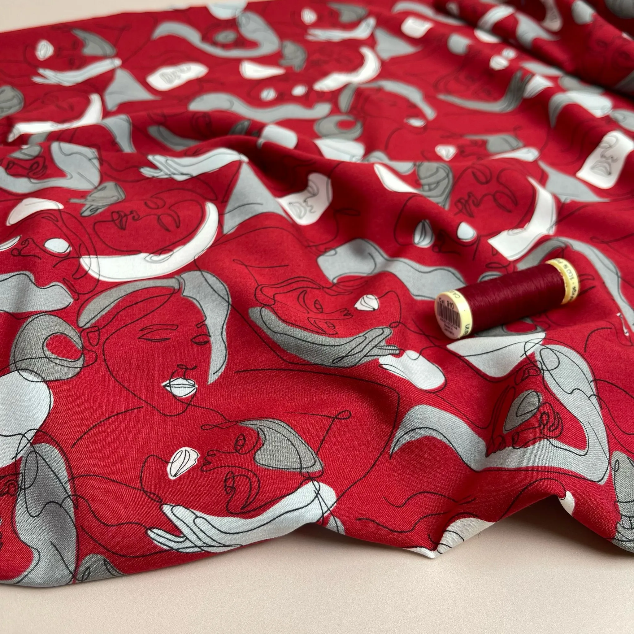 Faces on Red Viscose Fabric