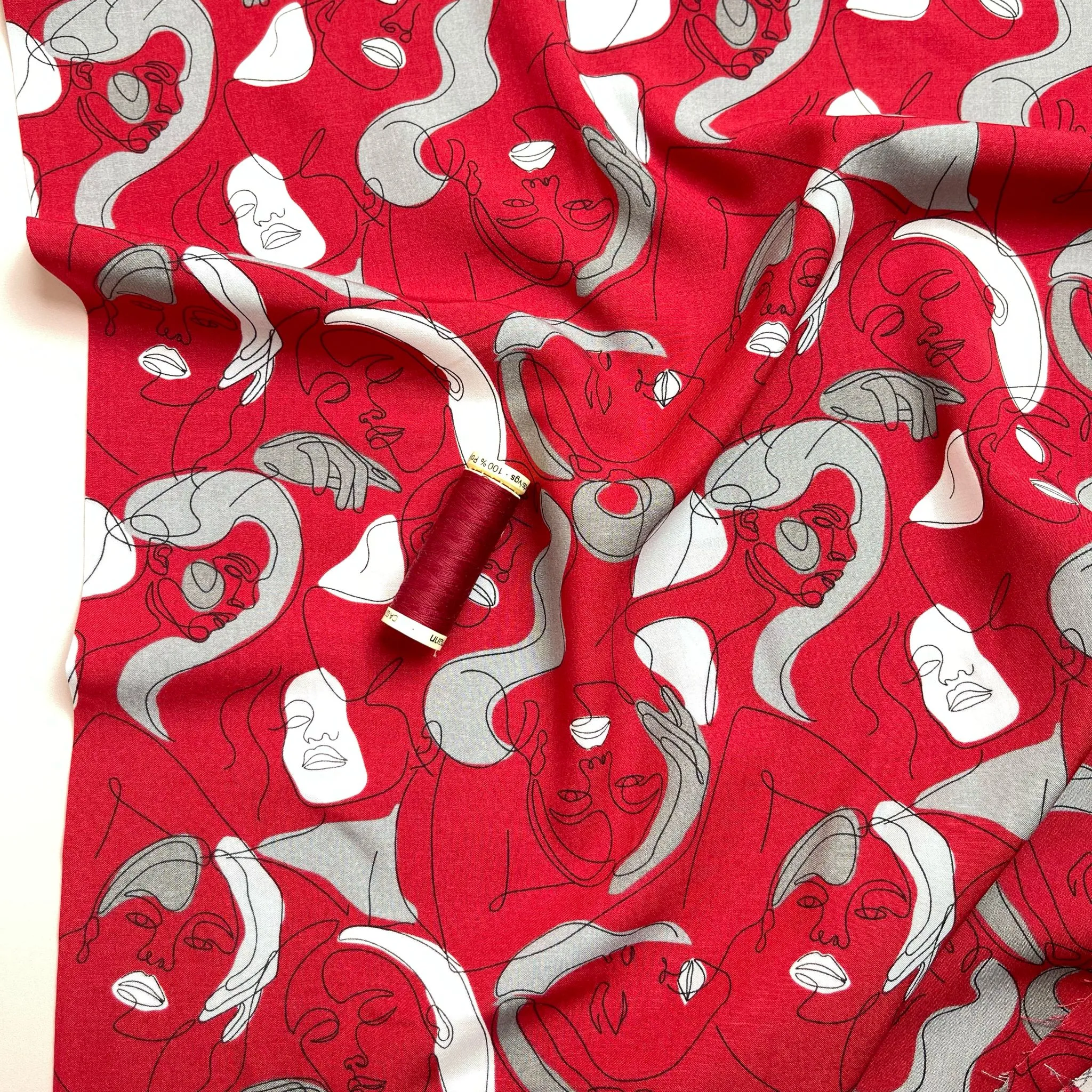 Faces on Red Viscose Fabric