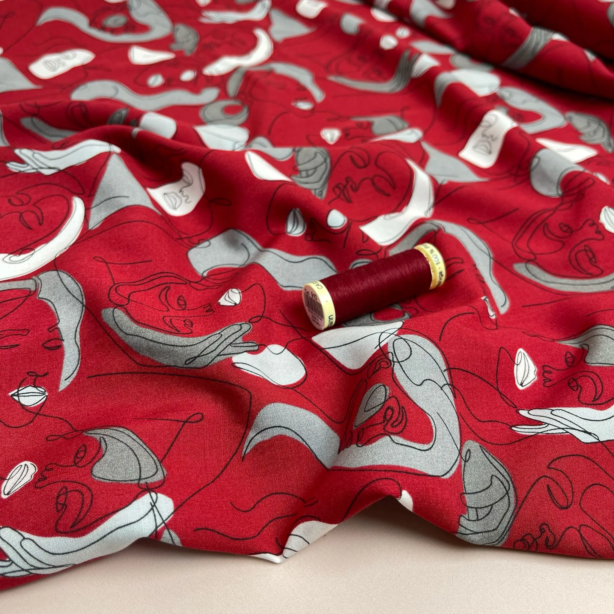 Faces on Red Viscose Fabric