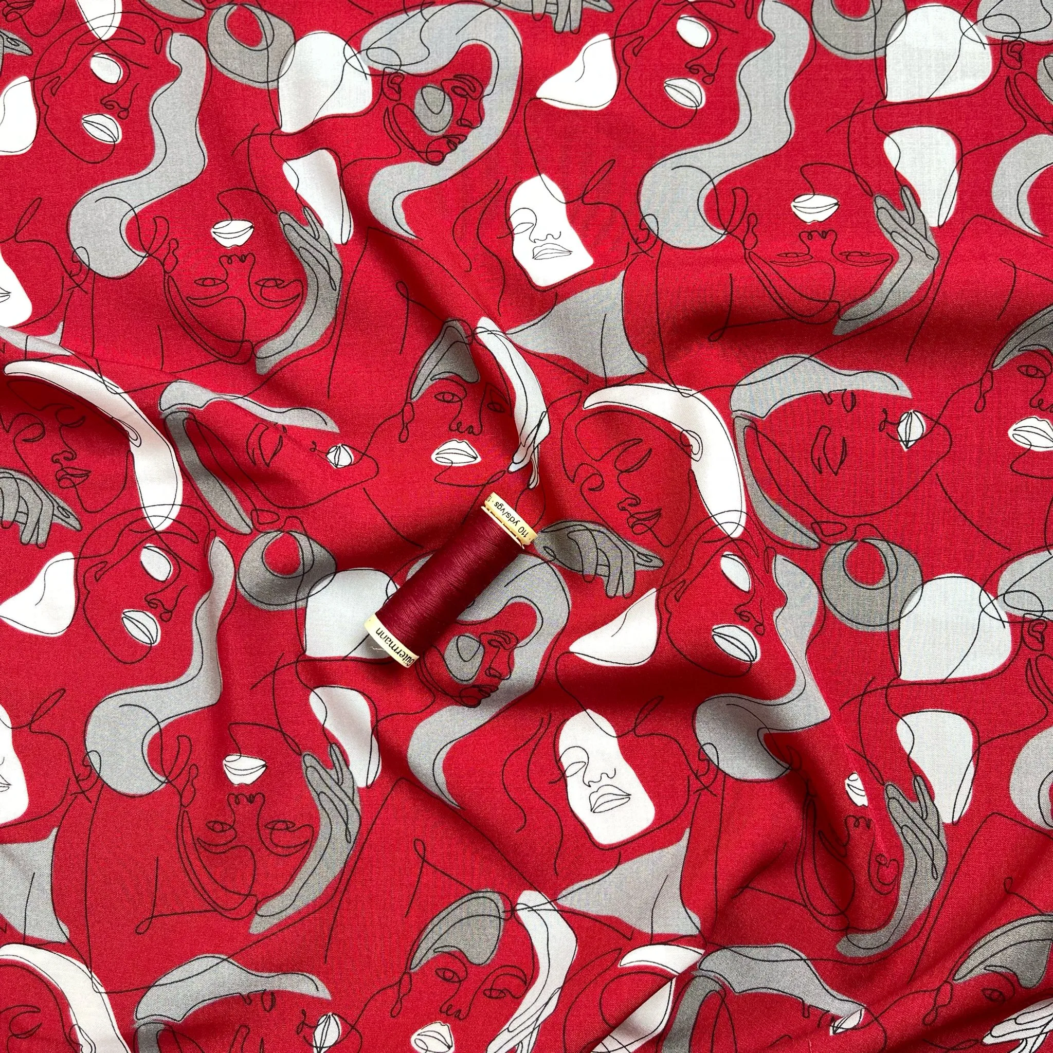 Faces on Red Viscose Fabric